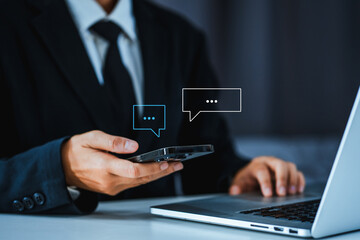 Chatbot chat AI concept, artificial intelligence Businessman using AI smart robot technology smartphone with Icon communication network social media network pop notification concept.