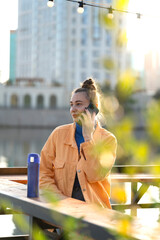 Poster - Young woman talking on a smartphone on the street.