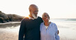 © Charlize D/peopleimages.com - Senior couple, smile and hug on beach, love and bonding on vacation, holiday and trip to ocean. Happy black people, embrace and support or trust, commitment and connection in marriage or retirement