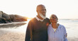© Charlize D/peopleimages.com - Senior couple, smile and hug by ocean, love and bonding on vacation, holiday and trip to beach. Happy black people, embrace and support or trust, commitment and connection in marriage or retirement