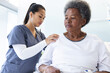 © WavebreakMediaMicro - Diverse female doctor testing senior female patient using stethoscope in hospital room
