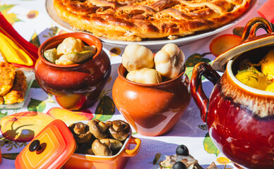 Wall Mural - Pickled garlic in a pot on the table with other dishes