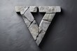 Stone letter V on a gray background. Typography, natural font alphabet