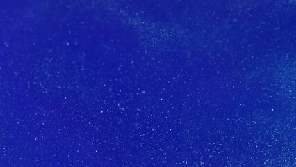 underwater background. shimmering fluid. bio luminescence. white blur microorganism particles illusi
