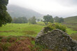 A stone hut above the shores of Rydalwater in the rain in the Lake District