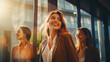 © Tierney - Happy businesswoman walking and talking through their office