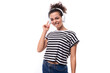 © Ivan Traimak - young cheerful curly brunette lady with black hair is wearing a striped t-shirt with wireless headphones