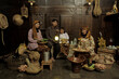 Portrait of Indonesian family wearing traditional clothes and sitting in the kitchen with happy expression