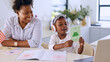 © Charlize D/peopleimages.com - Animal, mom or child learning on laptop for kindergarten busy with homework or school project at home. Geometric, card or happy mother by a creative girl listening or helping a for development