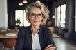© Anastasiia - Stylish Mature Woman Standing At Home Office, Arms Crossed