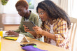 © Wavebreak Media - Happy diverse teenage friends studying with tablet and laptop at table at home