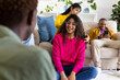 © Wavebreak Media - Happy diverse teenage friends using smartphone and talking in circle at home