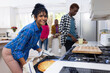 © Wavebreak Media - Portrait of happy diverse group of teenage friends cooking and making pizza in kitchen