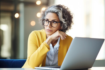 Mature business woman with laptop thinking, planning and reading online news report, project feedback or research ideas. Wonder, problem solving and professional female designer with doubt over design