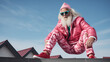 Fashionable Santa Claus in a pink suit on the roof of the building. Funny New Year or Christmas concept.