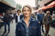 © CogniLens - Portrait of a content woman in her 40s sporting a rugged denim jacket against a bustling farmer's market. AI Generation