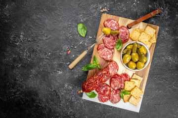 Wall Mural - Delicacies. Cheese, salami olives on a wooden board. Traditional italian antipasto plate. banner, menu, recipe copy space, top view