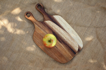 Two cutting boards with a yellow apple