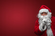 © Fxquadro - Santa Claus gesturing silence with finger on lips, mysterious holiday secret concept