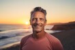 © CogniLens - Portrait of a joyful man in his 50s sporting a breathable mesh jersey against a stunning sunset beach background. AI Generation