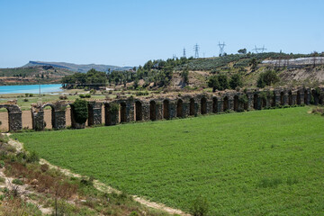 Wall Mural - Destroyed old aqueduct in Manavgat, Turkey. Oymapinar Lake, Turkey. Green Canyon in Manavgat region, Turkey. Emerald water reservoir behind the dam Oymapinar. 