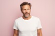 © CogniLens - Portrait of a satisfied man in his 40s sporting a vintage band t-shirt against a pastel or soft colors background. AI Generation