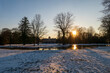 See am Schloss Favorite Foerch mit Schnee im Sonnenuntergang