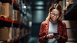 Smiling woman standing in a warehouse aisle, using a smartphone possibly to manage or check inventory.