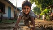 A cute little young Indian kid boy playing outside of his home in the garden on the grass. sunny golden hour day. 