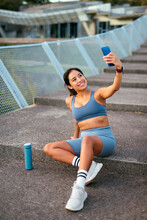 Latin American Woman Taking Selfie During Workout Break