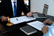 © sabthai - Lawyer hold gavel and work with his assistants