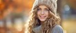 Amidst the picturesque winter backdrop, the beautiful woman with her radiant smile and flowing hair donned a cozy Merino wool cap, a fall sweater, emanating an aura of Christmas charm, capturing the