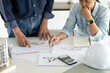 © sabthai - team of engineers and architects are discussing plans for building construction