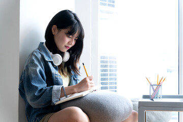 Poster - teenage girl is sitting and writing in a notebook  memo lessons