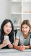 © golubovy - Gadget leisure. Technology fun. Content consumption. Two young teenagers girls scrolling social media blog on mobile device at cozy interior at home.