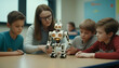 Teacher shows young kids how to program a mechanical robot.

