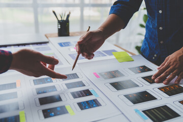 ux developers and ui designers brainstorm on tabletop mobile app layout design planning design color
