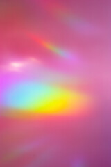Wall Mural - defocused abstract purple background with rainbow flare from sunlight, holiday backdrop, celebration