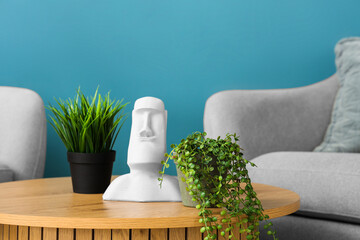 Different houseplants and decor on wooden coffee table in living room, closeup