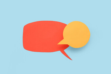 Canvas Print - Empty paper speech bubbles on blue background