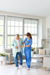 Poster - Young caregiver helping senior woman to walk at home