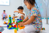 Fototapeta Desenie - Toddler 2 year girl enjoying build toy block happy girl learnning education