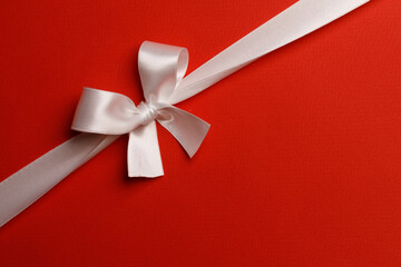 Wall Mural - White gift bow on red