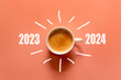 Happy new year and Merry Christmas 2024. Cup of coffee change and download 2023 to 2024 on orange background. Start up and New Year Concept. Copy space