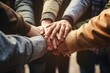 A picture of a group of people joining hands in unity. 