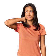 Wall Mural - Young Filipina with long black hair in studio touching back of head, thinking and making a choice.