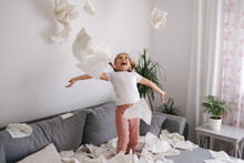 Adorable Little Girl Make A Mess At Home. Five Year Old Girl Throws Napkins In Living Room