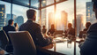 Successful Business man boss sitting in a boardroom with his team on Defocused Bokeh flare office background