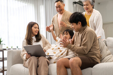 Wall Mural - Father and mother with asian kid girl learn on laptop computer reviewing lesson study with online education e-learning.student look for educational knowledge in homeschool at home.Education