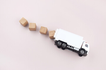 White toy truck with boxes on a light background, space for text.